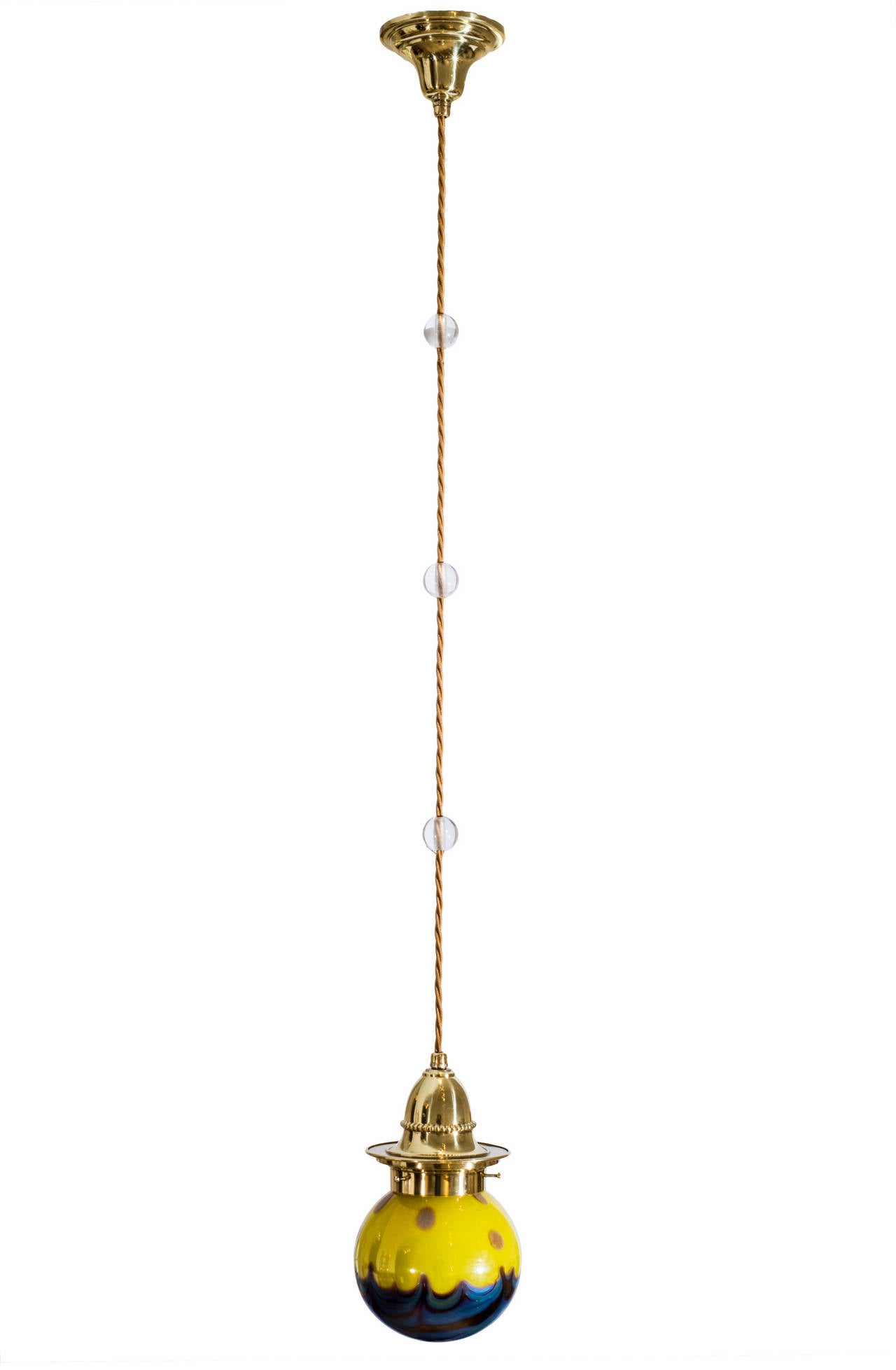 This hanging lamp was executed ca. 1902 in the typical „Wiener Jugendstil“ and is in a very god condition. The three glass orbs are a common style element of the Wiener Jugendstil and can be found on some contemporary photographs of hanging lamps.