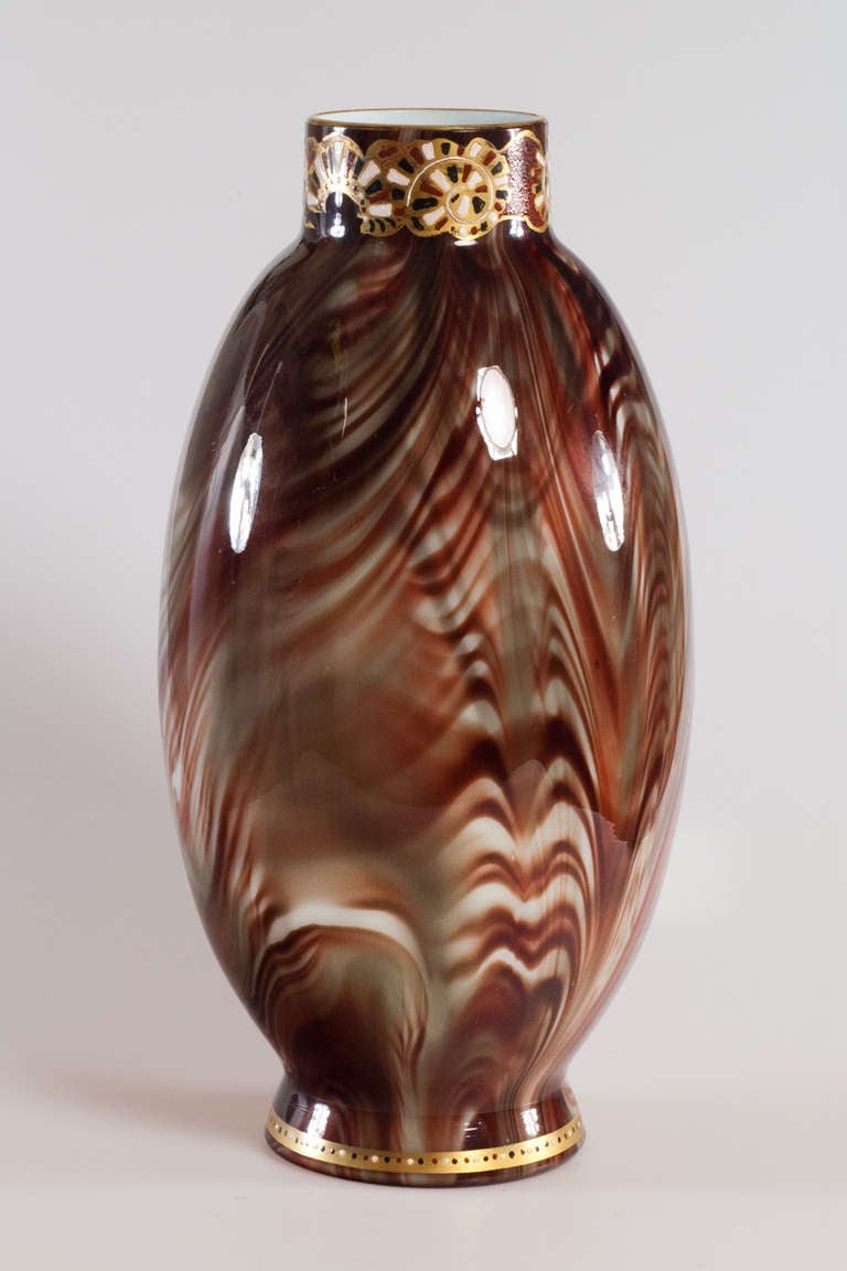 Vases with the Onyx decoration where the products that made the art glass studio Johann Loetz Witwe famous. Glass was processed in a special manner where the result was a semi-precious stone-like appearance. Many vases were decorated afterwards with