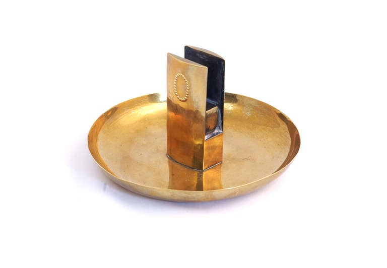 This ashtray was designed by the famous viennese architect Josef Hoffmann in the time around 1928. It is made of brass and is marked at the bottom with the monogram 