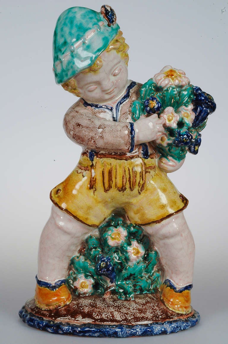 This is a pottery putto from the manufacturer Sommerhuber in Steyr. Such figurines were very in mode in this time. The putto wears a so called 