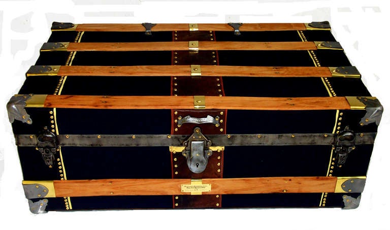 Covered in black canvas duck with leather side binding.  All original hardware, working Eagle lock and key.  Hardware patent dated 1891.