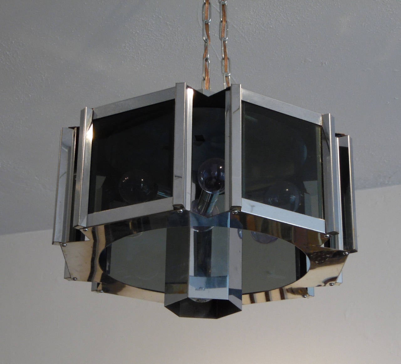 Beautifully designed modernist chandelier by Robert Sonneman holding six bulbs behind six smoked glass lenses and one downlight bulb. Comes with 36" of chrome chain attached to the top of the chandelier for hanging.