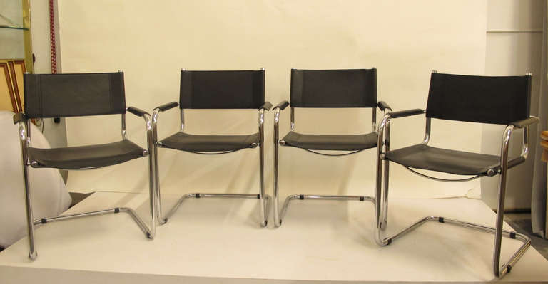 Four leather and chrome dining chairs designed by Mart Stam.