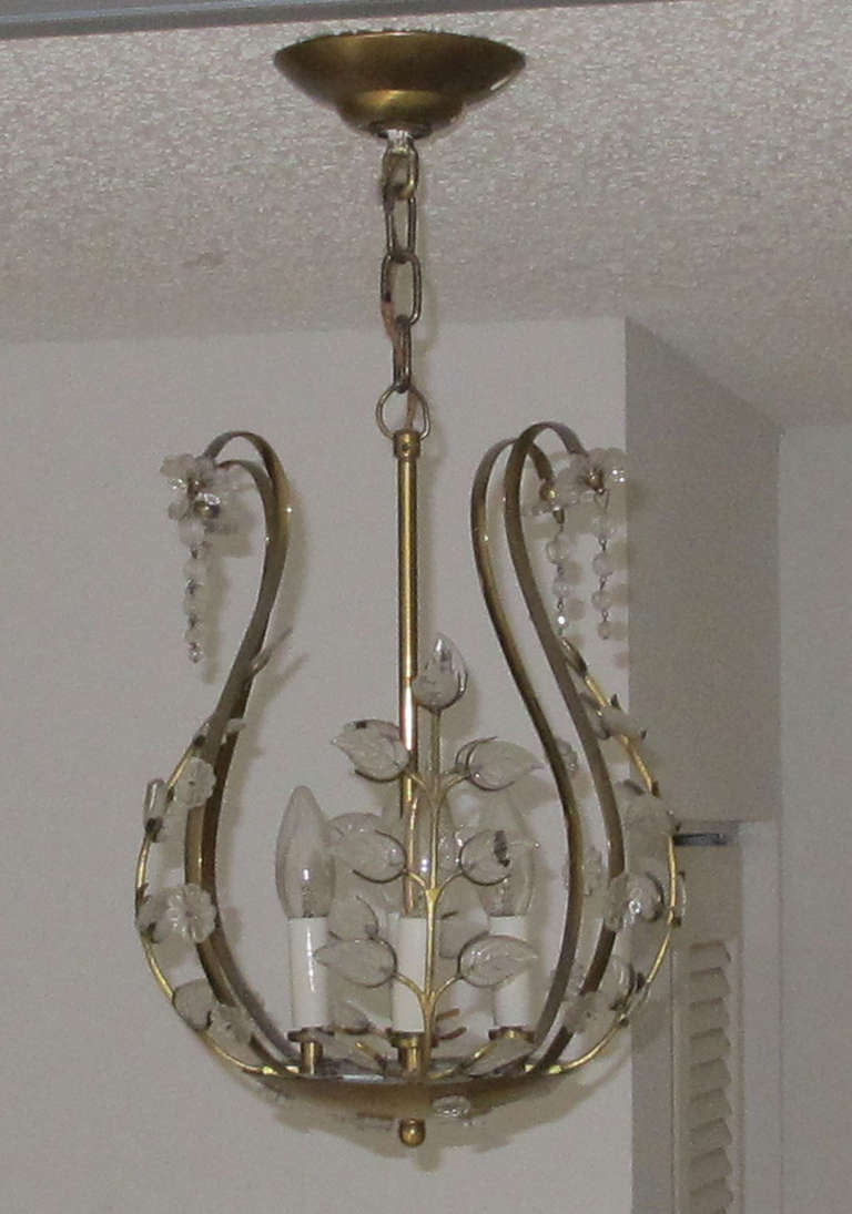 Glass buttons and leafs adorn this attractive chandelier. Good size for a hall way or powder room