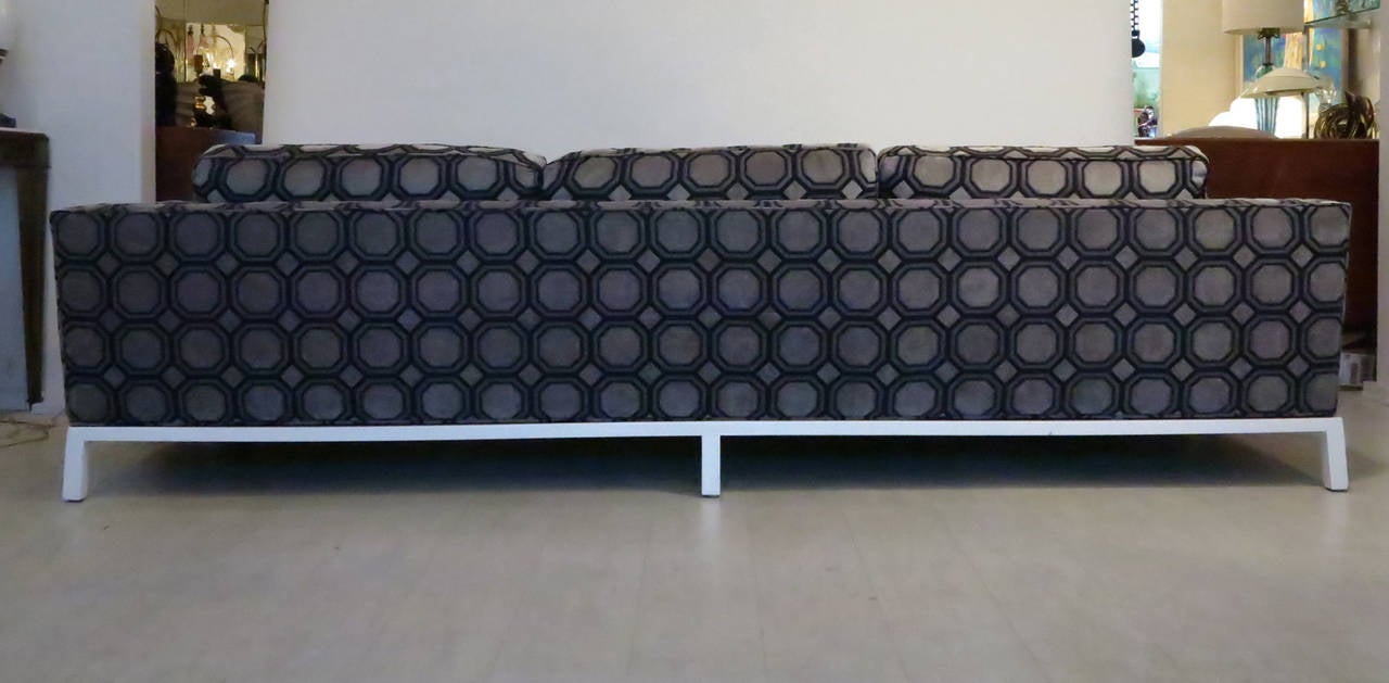 Beautifully designed and crafted nine foot (9') long sofa by Harvey Probber. The painted, solid wood platform base supports a single seat cushion, three back cushions, and two bolster cushions serves to create an extremely soft and comfortable