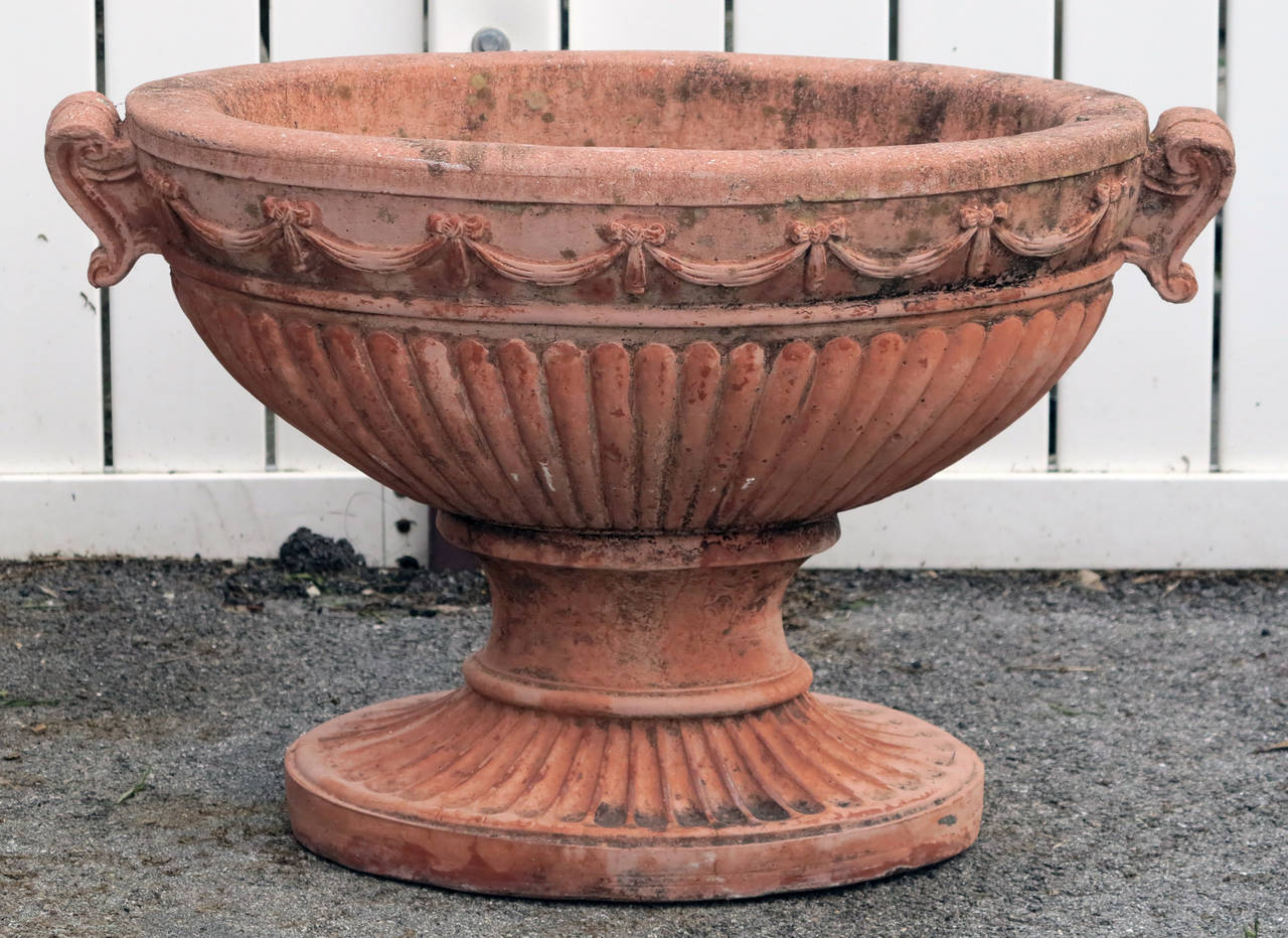 Terracotta finish cast stone oval planters. Beautifully aged antique finish.