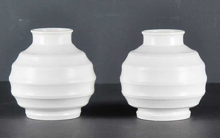 Beautifully designed and crafted rare pair of Keith Murray for Wedgwood moonstone hand thrown ridge vases. Keith Murray (1892-1981) was a New Zealand born architect and designer who designed ceramics, glass and metal ware for Wedgwood in the 1930's