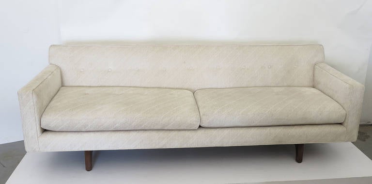 Beautifully designed and crafted model 5125 sofa.by Edward Wormley for Dunbar. Iconic mid century modernist work with great proportions and detailing, this sofa has a mahogany base that extends up the back of the sofa to convey the impression the