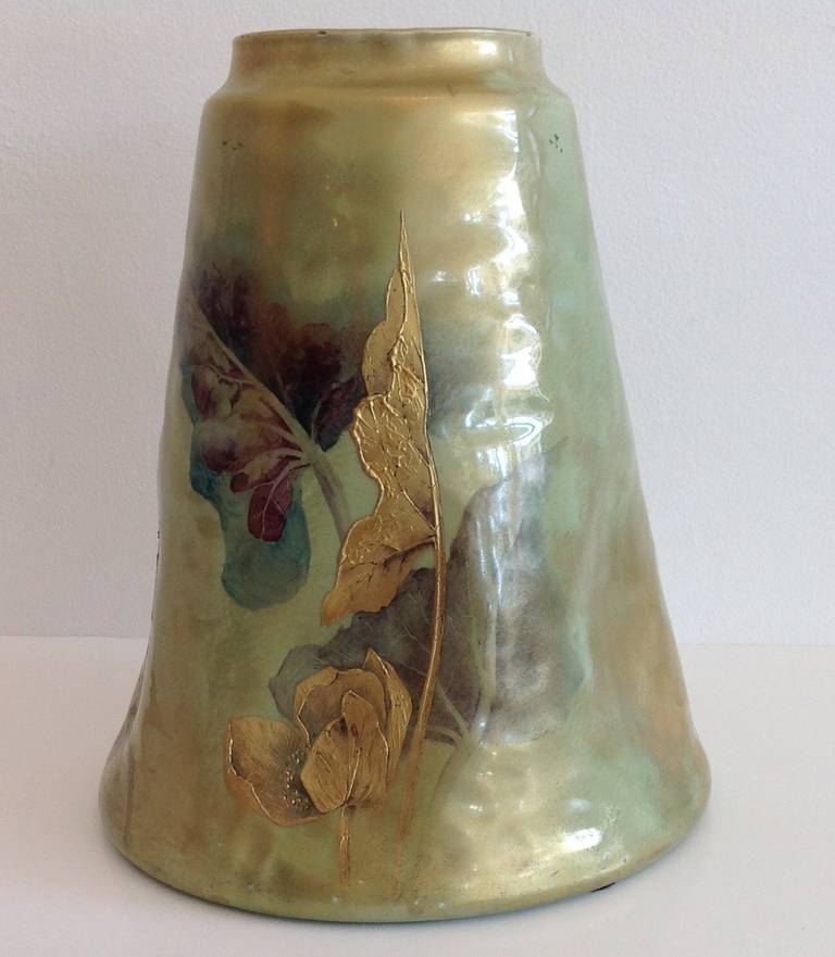 Beautifully crafted French Art Nouveau vase by Clement Massier. Elegant tapering conical form covered with a lustrous, glossy, irridescent celadon glaze decorated with hand painted gilt flowers and foliage.