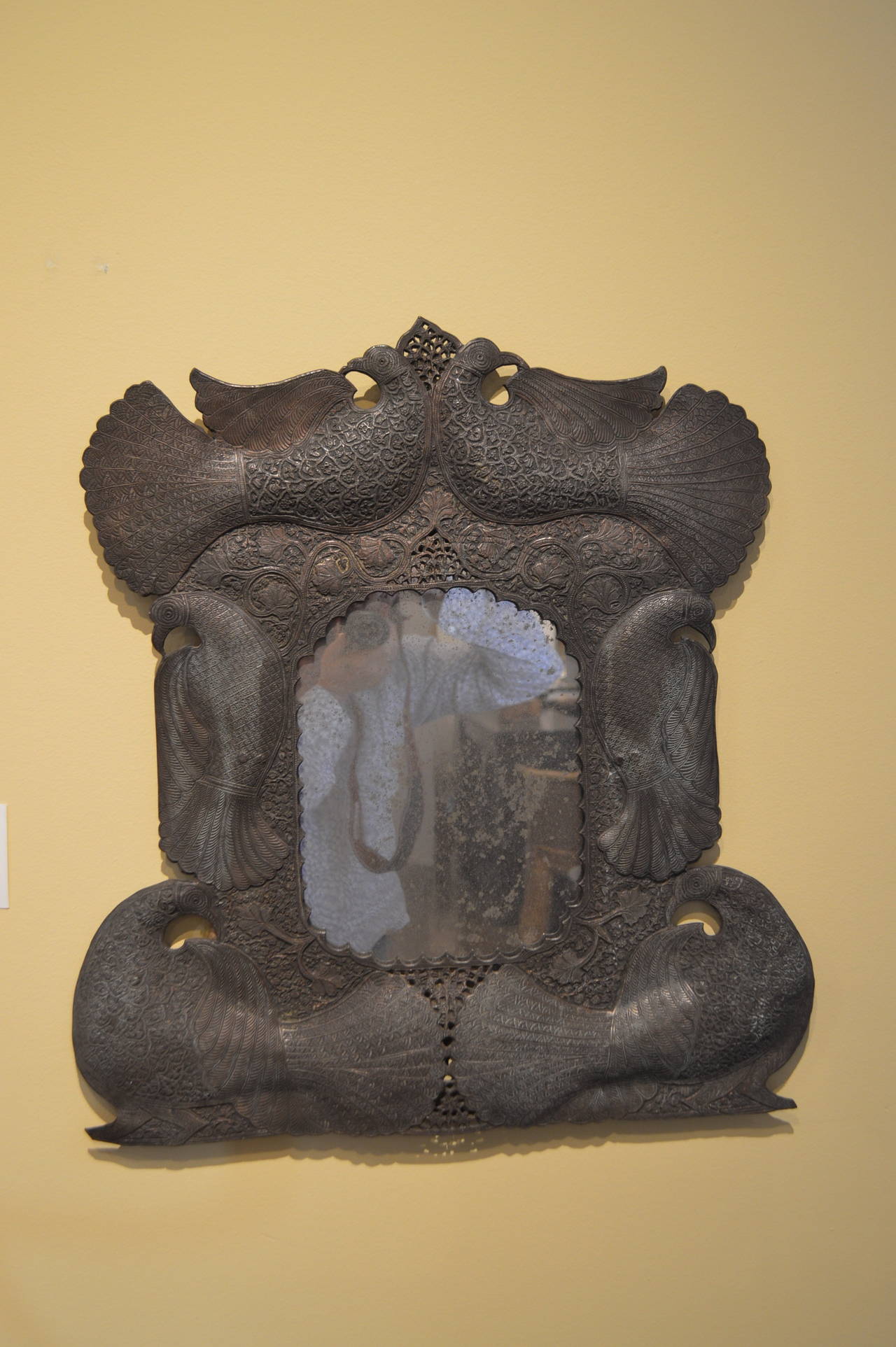 The craftsmanship of this mirror is exquisitely executed.
Most likely an alloy of copper and some other metal.