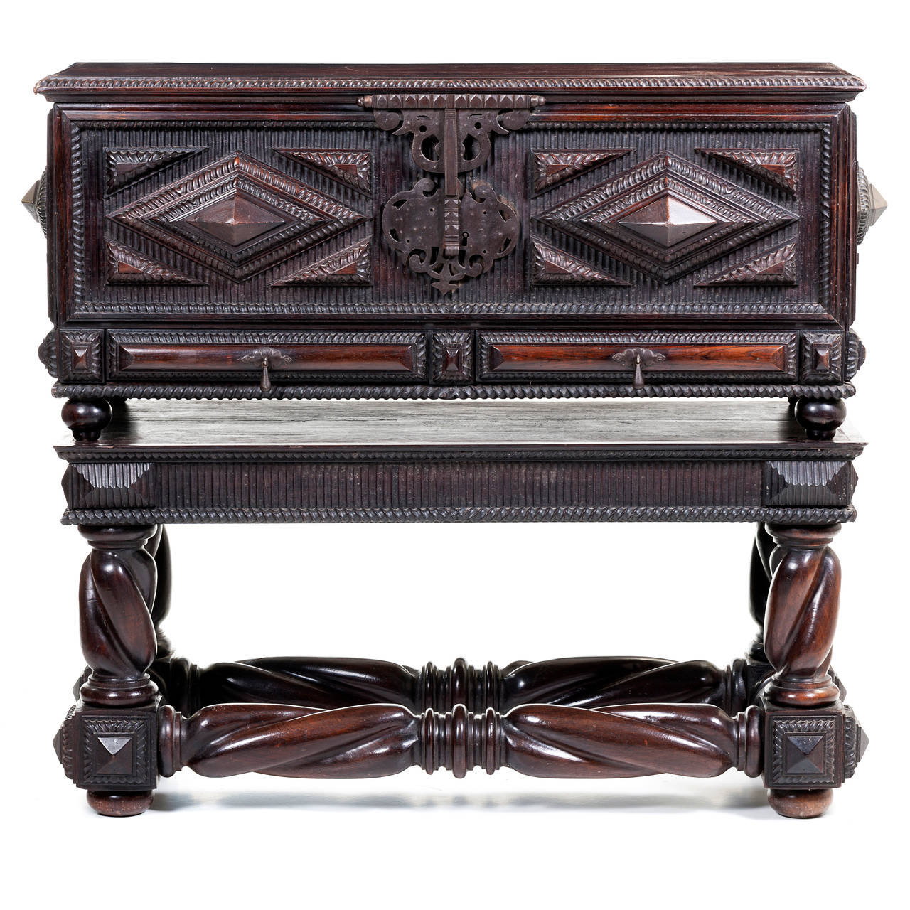 A magnificent Portuguese Baroque chest circa 19th century superbly carved out of solid Brazilian rosewood, with two lateral doors and brass mounts. The interior locks were removed.
The lower case on spiral turned stretchers entirely carved of solid