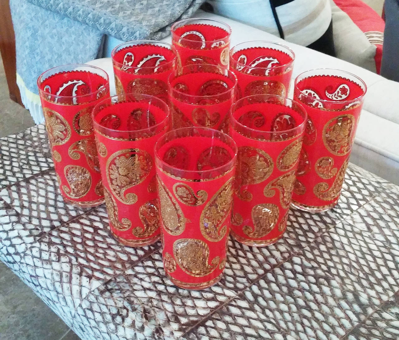 Set of nine red and gold paisley designed highball glasses, unmarked.