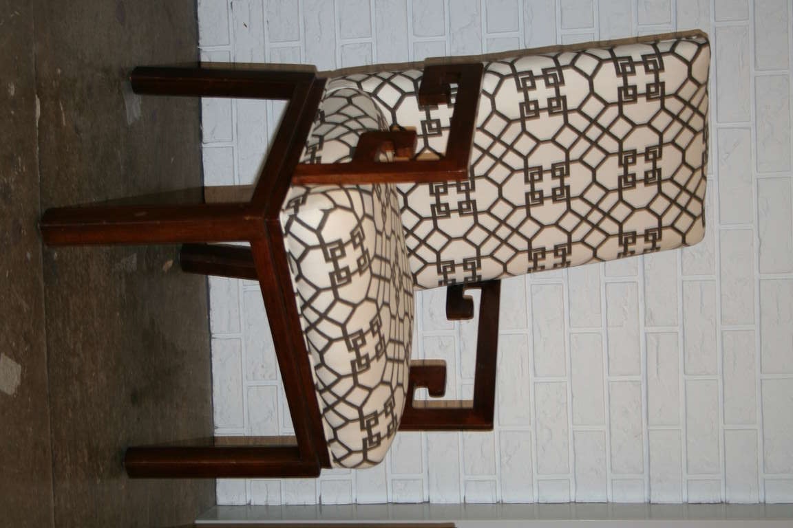 Pair of walnut arm chairs with Greek key arm detail and upholstered in Chinese Chippendale brown and white fabric.