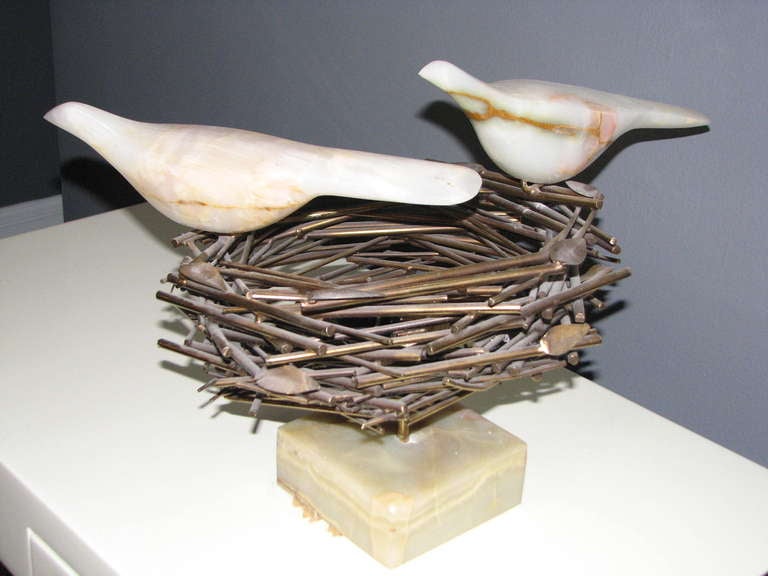 Rare Curtis Jere sculpture with mixed materials.  2 onyx birds perch on a brass nest that holds 3 marble eggs. The sculpture rests on an onyx base. The brass nest holds three eggs - 2 from onyx and 1 from marble. They are separate from each other