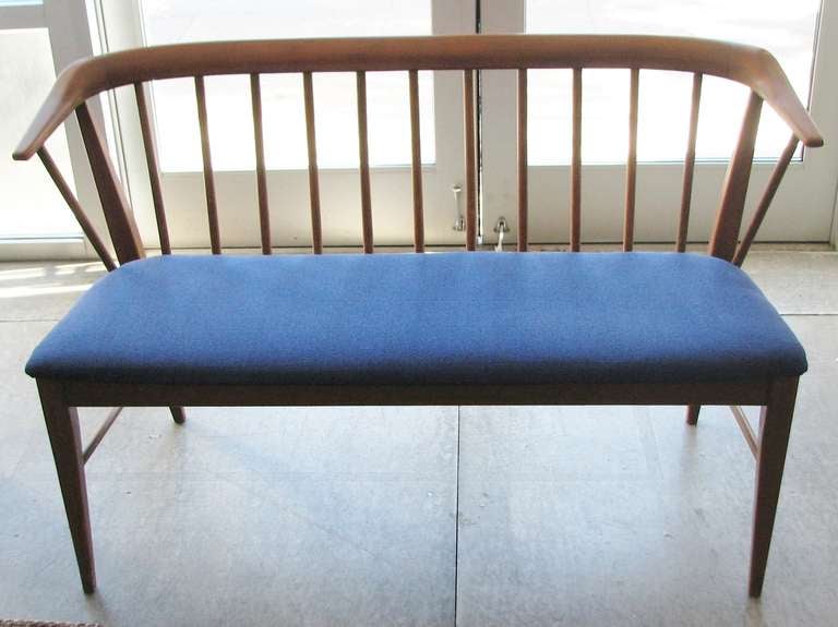 Danish Modern walnut deacons bench with blue upholstered seat.