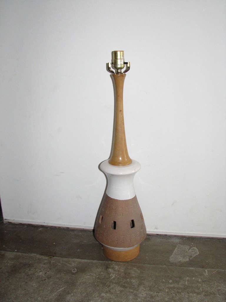 Pair of white and natural pottery lamps with wood accents. No shades. Height is to harp.