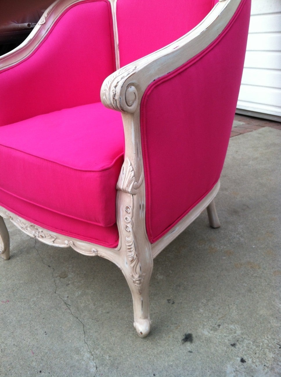 Beautiful large armchair in the French Louis XV bergere style. Solid wood in distressed white finish. Newly upholstered in pink hot cotton.