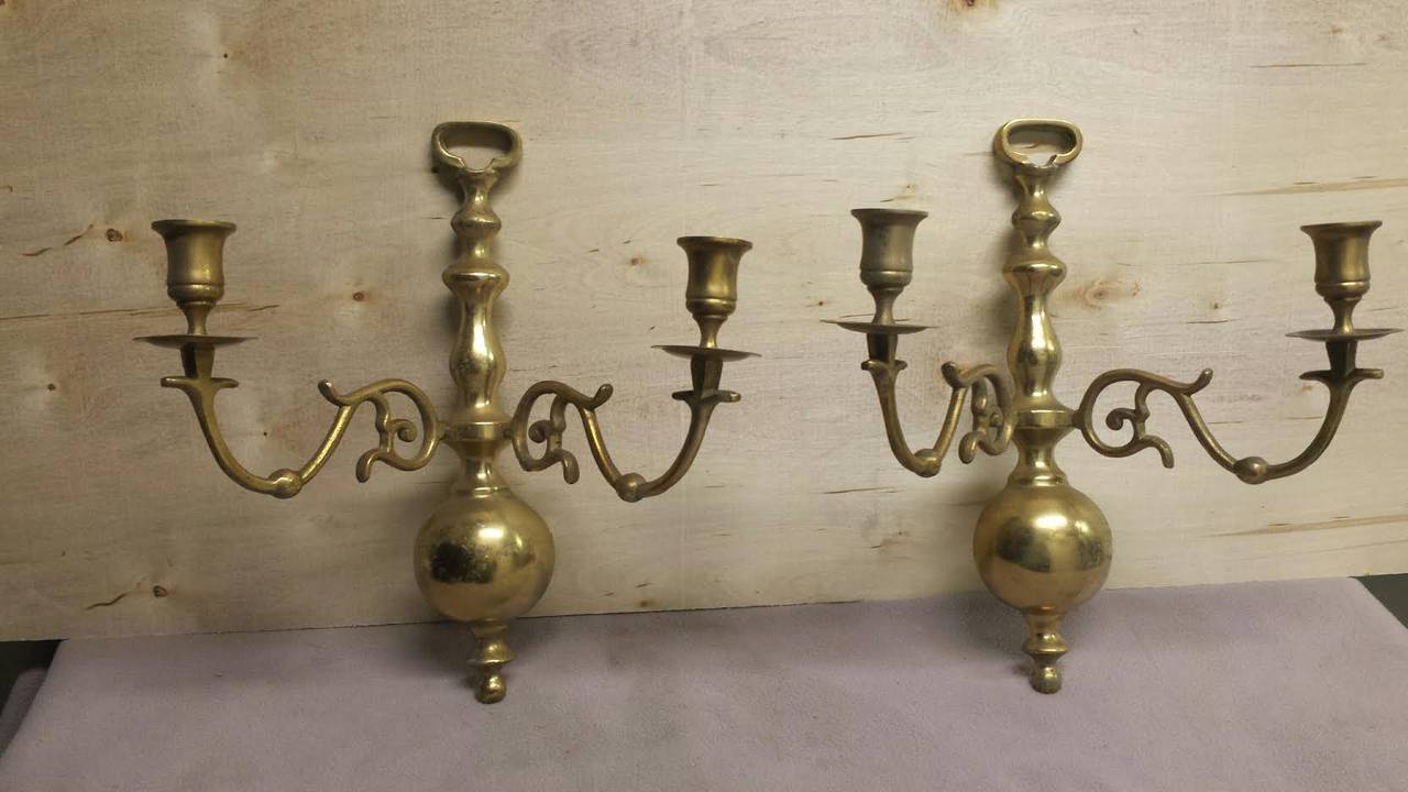 A pair of mid century wall sconces candle holders. Made from brass.