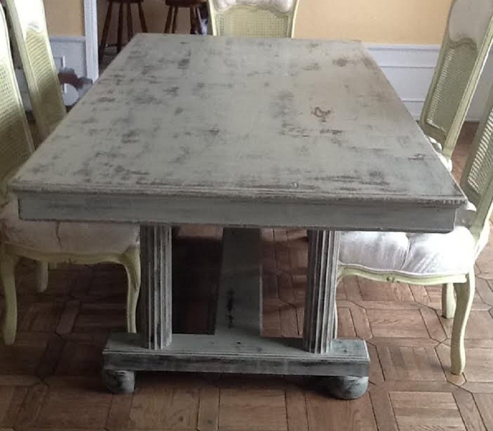 A french country farmhouse dining table. Painted in distressed grey (shabby chic).
