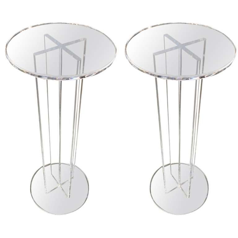 Pair of Mid Century Clear Pedestals with a round Top. Made of Lucite. Pedestals do not match in Size.