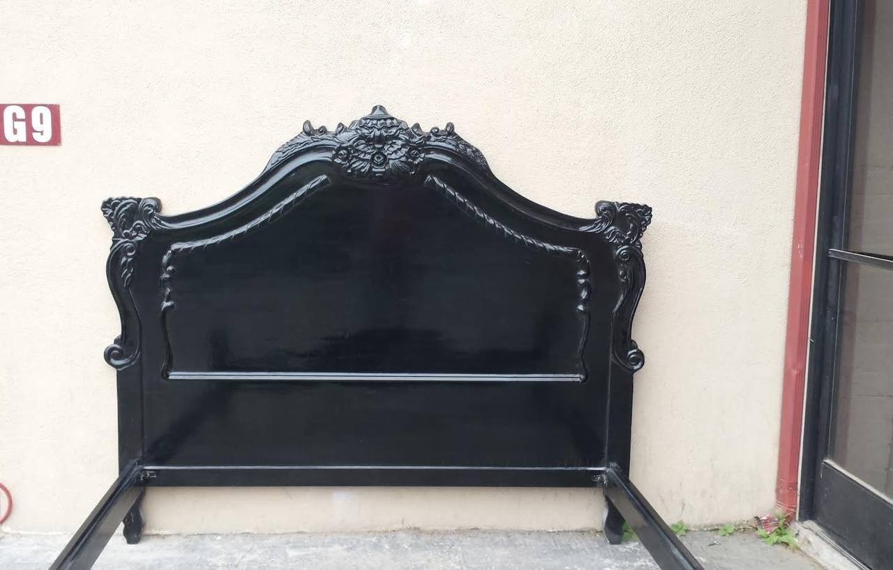 Beautiful bed with hand carvings on the foot board and headboard. The wooden frame is newly painted in glossy black finish. Will fit a standard King size Mattress 76