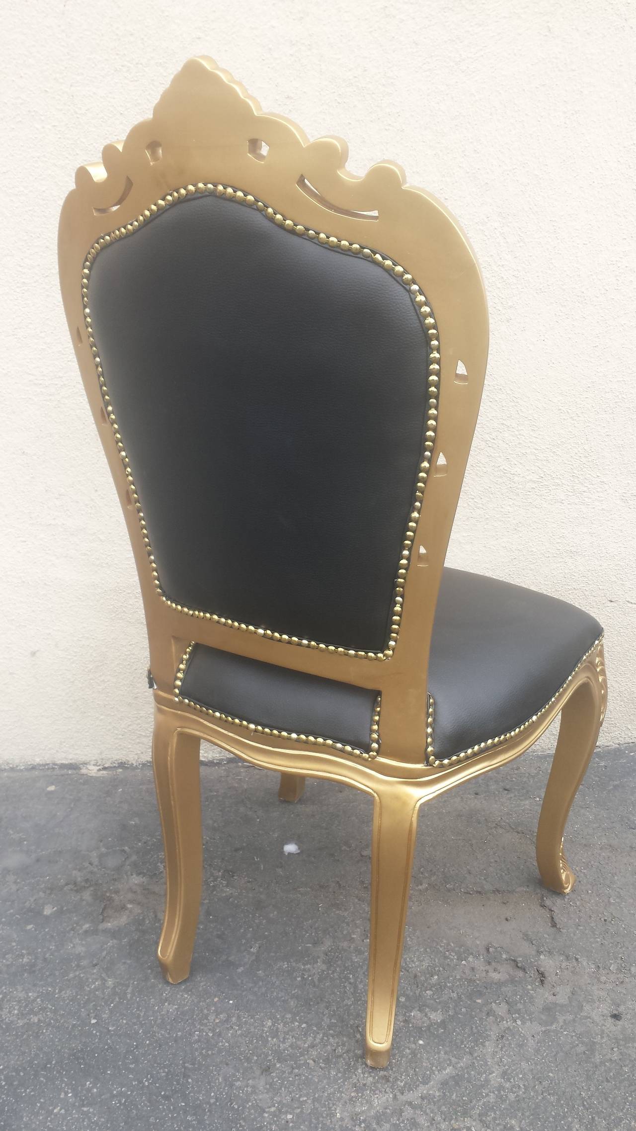 Hand carved French style side chair and dining chairs. Finished in gold and deep tufted back in faux leather.
Newly painted and upholstered. 
Two chairs are available.