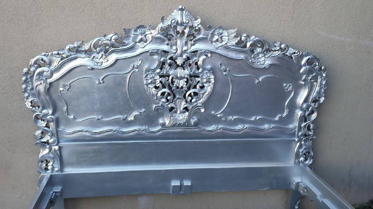 Hand caved beautiful French Rococo or Louis XV style bed. Solid mahogany wood. Finished in silver with scrumptious carvings. Will fit a standard US Queen size Mattress. Bed comes with slats to place a mattress on top. Please contact us for sizes and