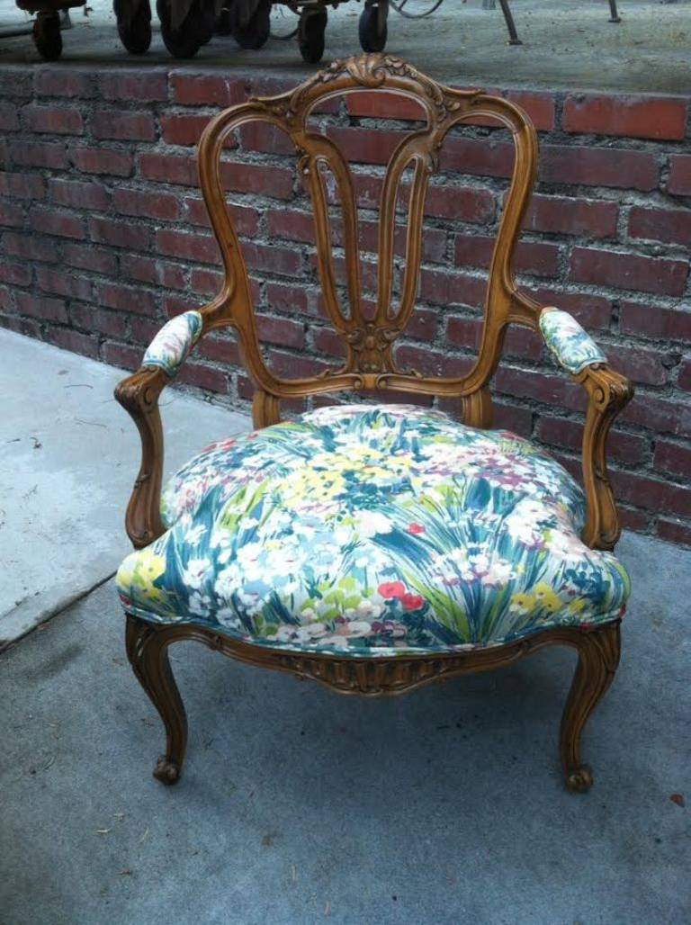 Pair arm chairs. Hand carved wood details .Upholstered in floral motif fabric.
