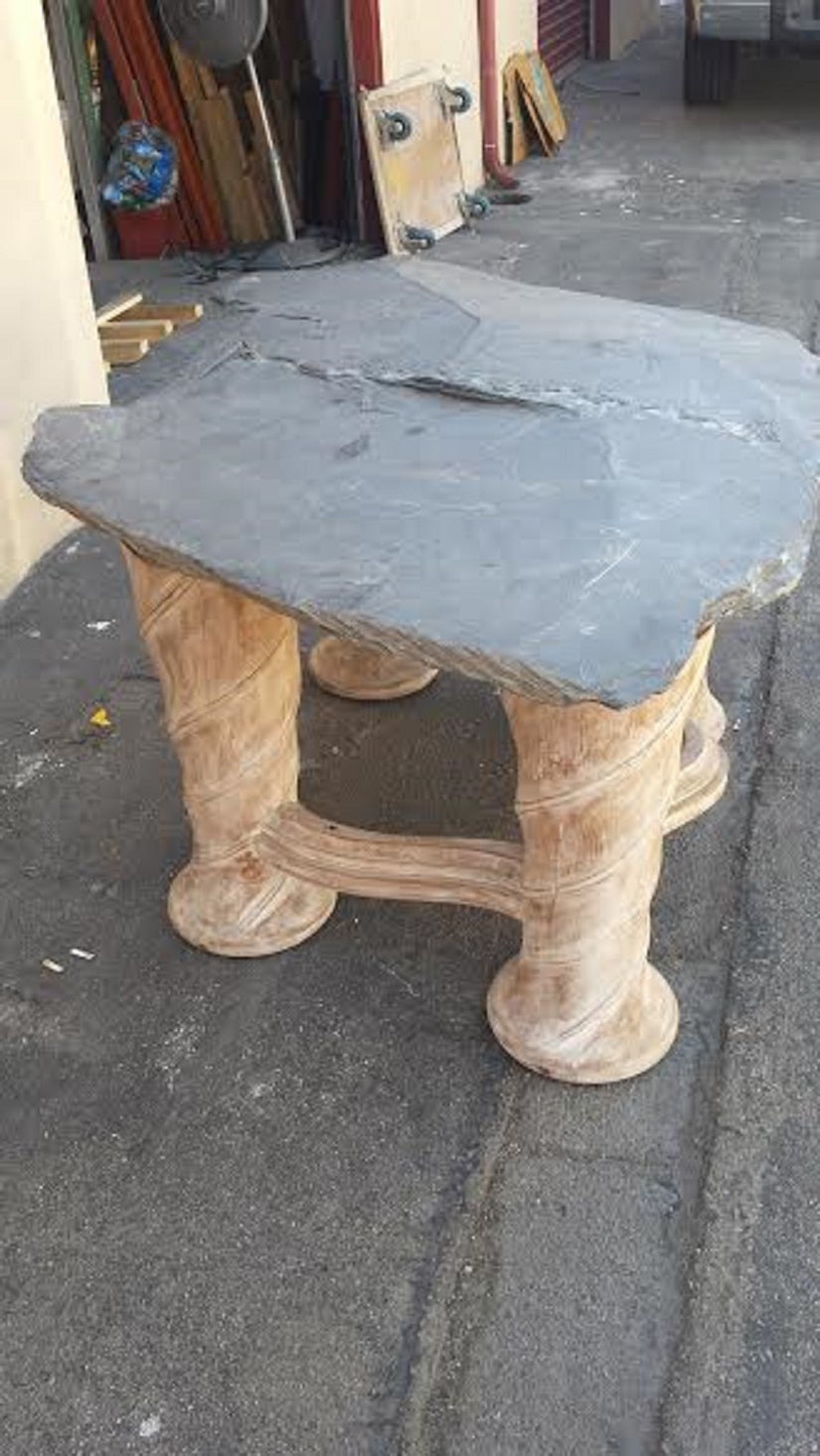One of a kind free form table with slab slate top and carved wooden base.
The top is extremely heavy, approximately 600 lb.
Wood carved base. Massive and Sturdy.