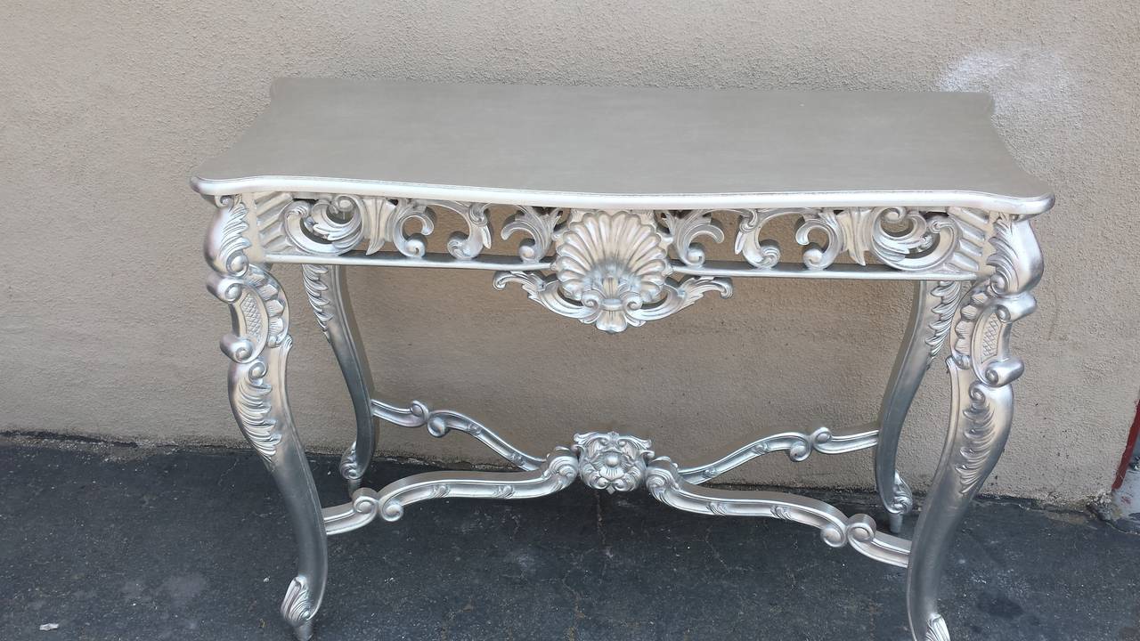 Louis XV style console table. Hand carved from Mahogany and finished in silver leaf.