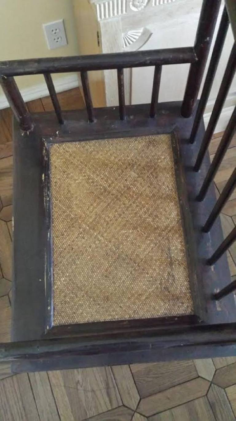 Pair of Chinese arm chairs in HuanHaua/Li Style. Slatted back with Cane seat. In very good condition with nice patina shown.  Made from core of Elm wood, the chairs are very solid and have been kept in excellent condition.