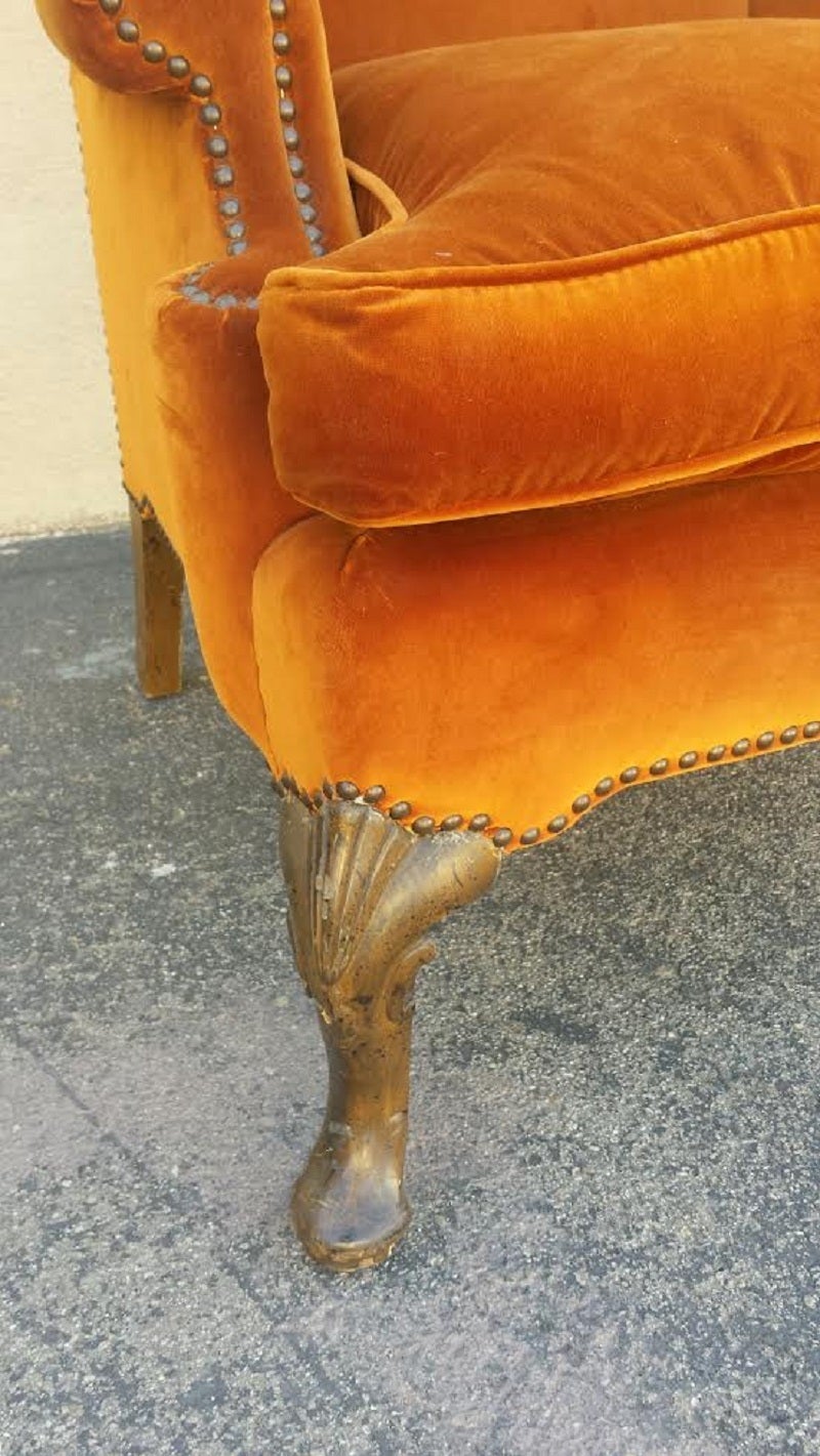 Pair French Louis XV style elegant Wingback armchairs. In original condition in gold orange velvet with nail heads trim. Seat cushion is down.