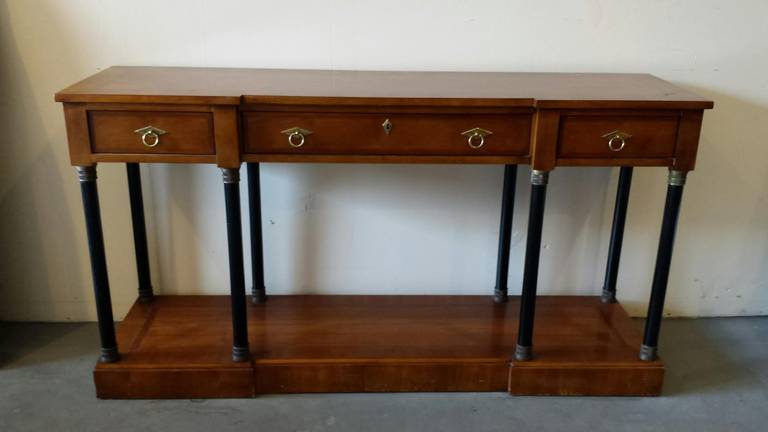 Beautiful Art Deco console table. Made from burl wood with brass accents on the legs. Hardware made of brass. Three drawers for storage.