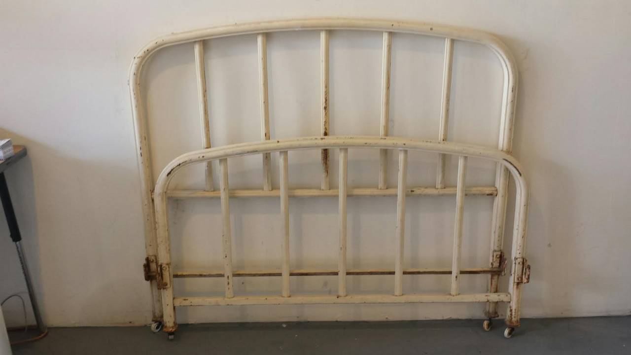 Beautiful French Country Provincial Iron Bed. Will fit a standard Full size mattress. With iron surface rust and original paint and beautiful patina shown. Sits  on 4 porcelain casters. We can repaint the bed for you or to apply clear coat. Bed