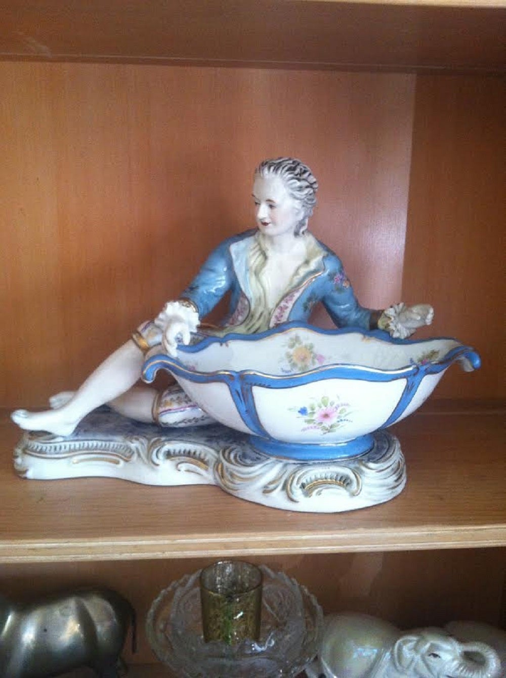 Meissen Figure of a boy offering a sweetmeats bowl  / dish. Floral encrusted and painted with floral subjects. In excellent kept condition.
