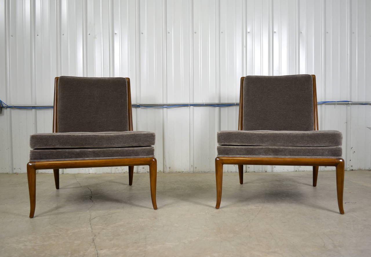 A pair of slipper chairs designed by T.H. Robsjohn-Gibbings for Widdicomb. Both are newly restored. They have been refinished and reupholstered in mohair.