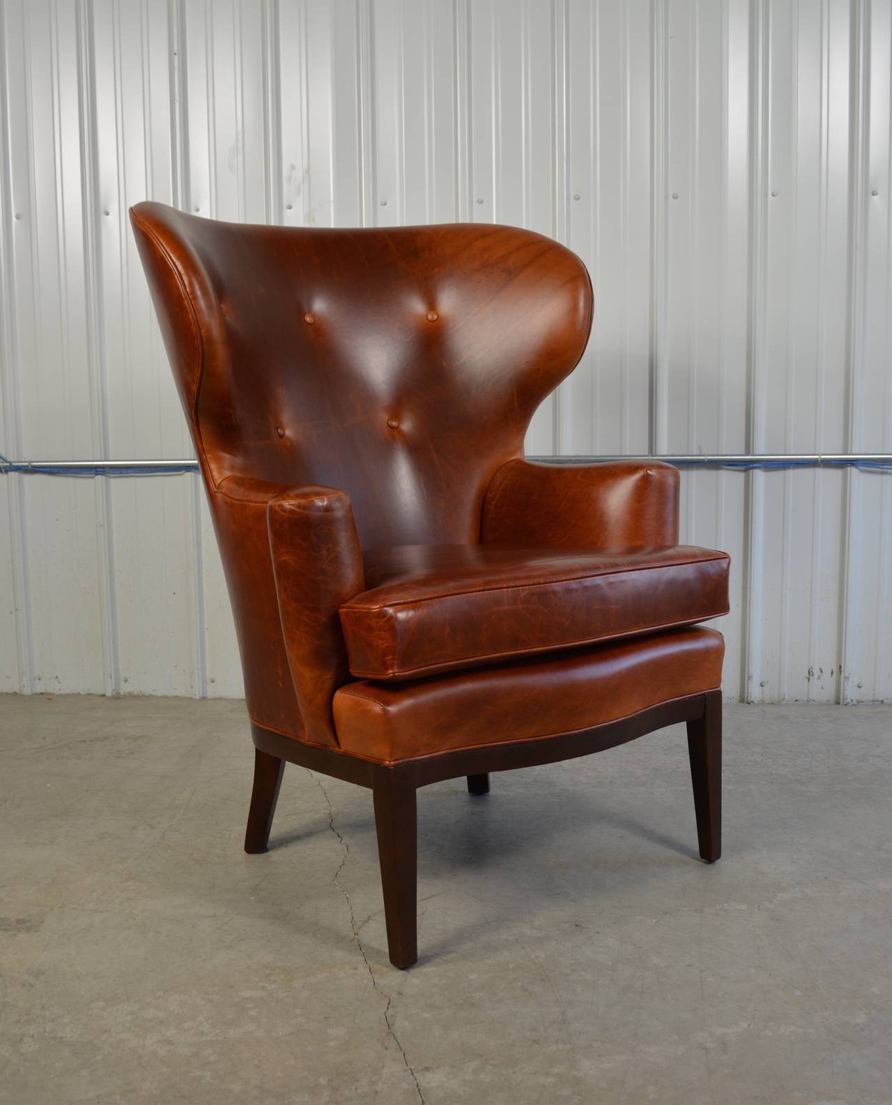 A rare early wingback chair by Edward Wormley for Dunbar in chestnut leather.