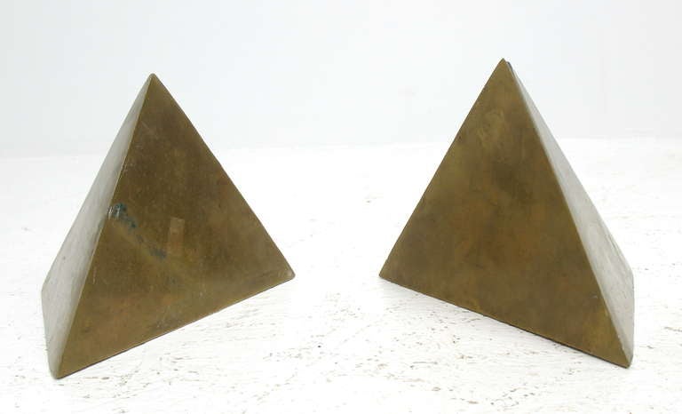 A pair of brass pyramid bookends.  Brass shows a nicely aged patina.