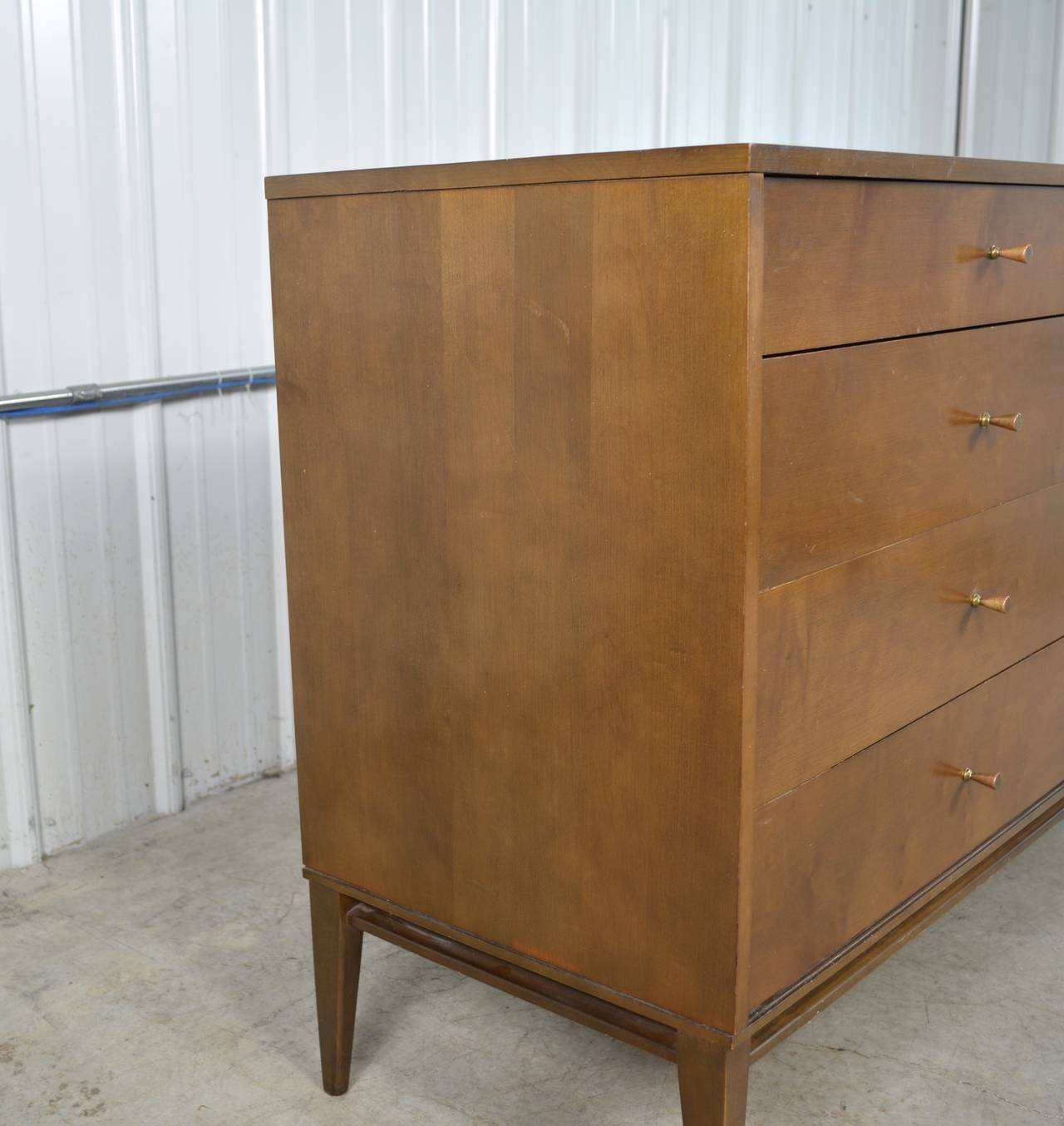 An eight-drawer dresser by Paul McCobb for the Planner Group by Winchendon. Brass hardware.