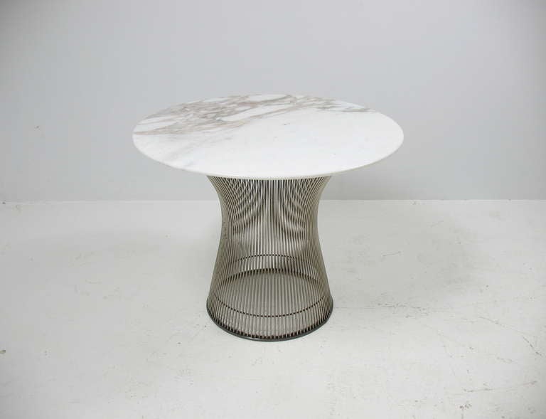 A nickel plated side table with carrera marble top by Warren Platner for Knoll.