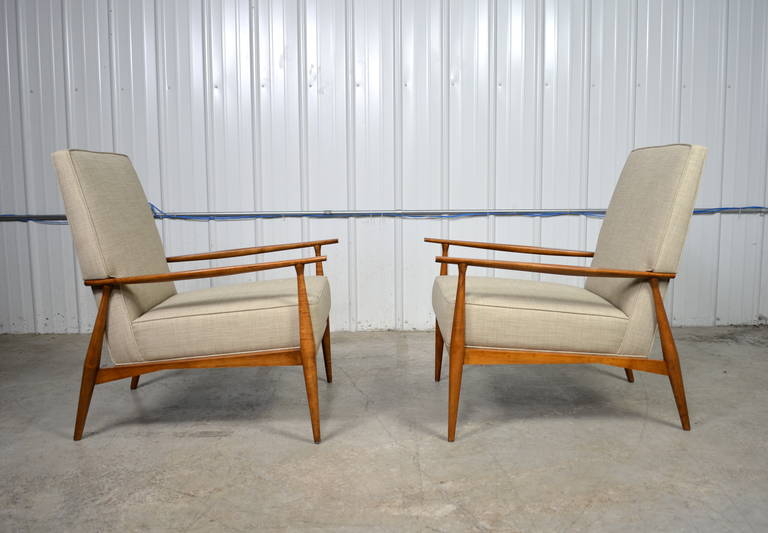A pair of Paul McCobb lounge chairs for Directional. Sculptural solid wood frames. Newly refinished and reupholstered.