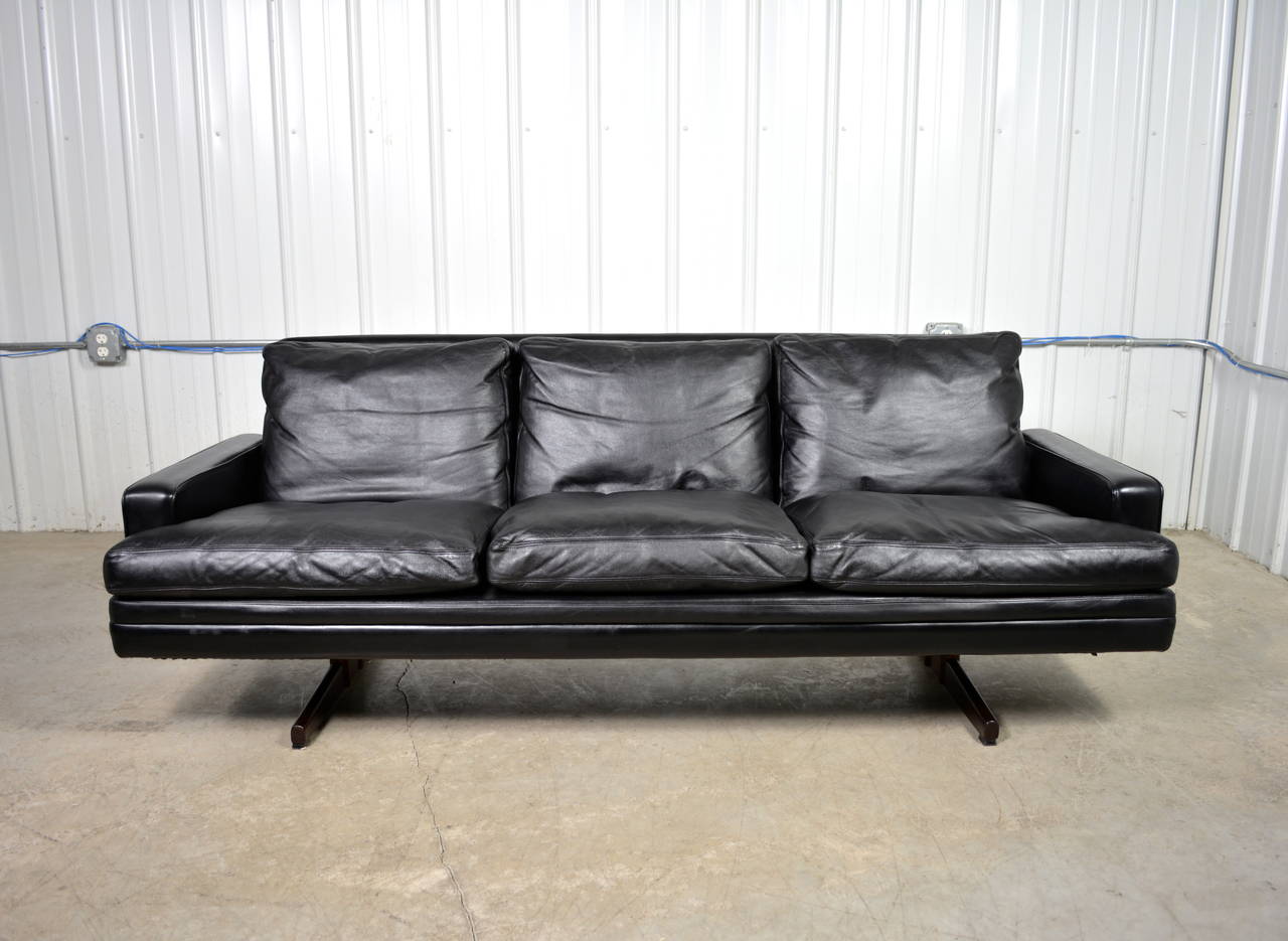 A sofa by Norwegian designer Frederik Kayser for Vatne Mobler.  Black leather upholstery, down filled cushions and rosewood legs.  Labeled.