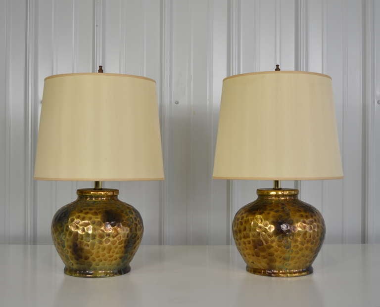 A pair table lamps with hammered copper style finish.  Both have a nicely aged patina.