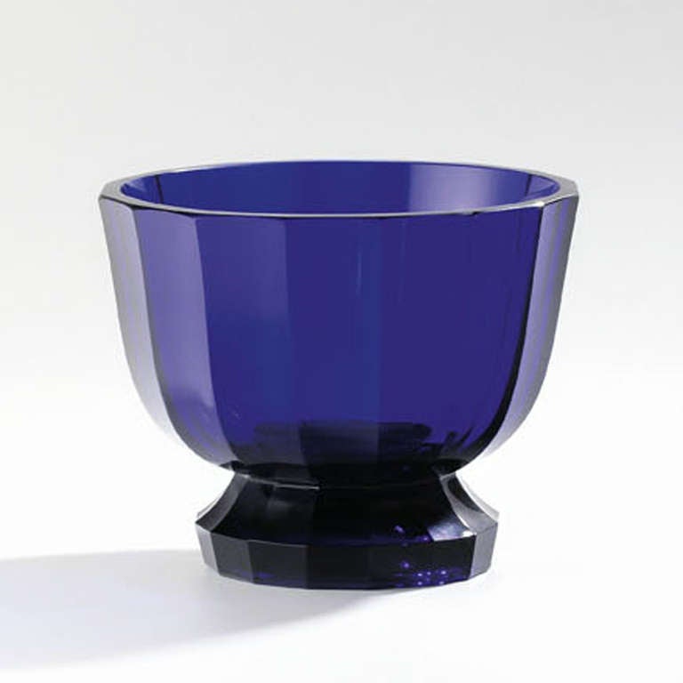 Manufactured by Meyr’s Neffe, Adolf, for the Wiener Werkstätte.
Blue glass, colored paste, sides decorated with sixteen sections set off against one another in broad cuts.
