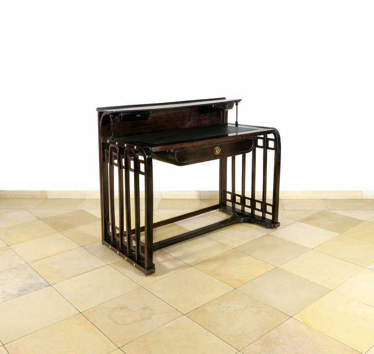 Desk, design circa 1905/ Manufactured by Jacob & Josef Kohn, Vienna, no. 500 of 600<br />
Beech, stained palisander and polished, brass fittings and brass rivets, desktop with new leather.<br />
H 96 cm, W110 cm, D 59.5 cm
