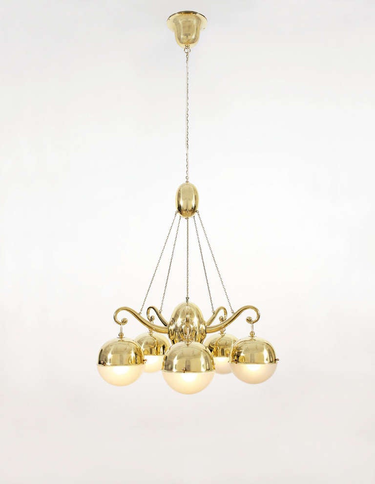 Five arm Chandelier, circa1918, manufactured by the Wiener Werkstätte, model number M 2898 or M 2899. Brass, newly electrified. The opal glass elements have been replaced after the original model. Length: 153 cm, Diameter: 70 cm.
Provenance: Welz