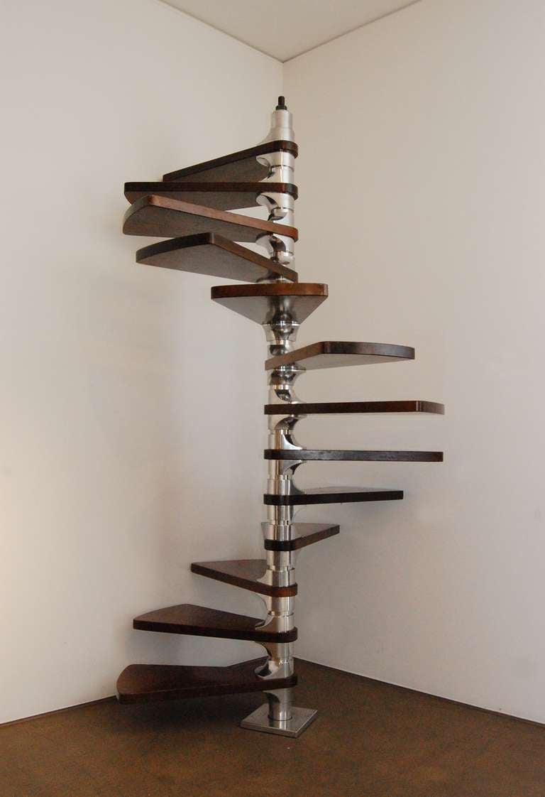 Adjustable spiral staircase designed by Roger Tallon. A central aluminium alloy column supports 14 rosewood steps. Tallon is widely known as one of the pioneers of French industrial design in the 20th century. As well as creating a diverse