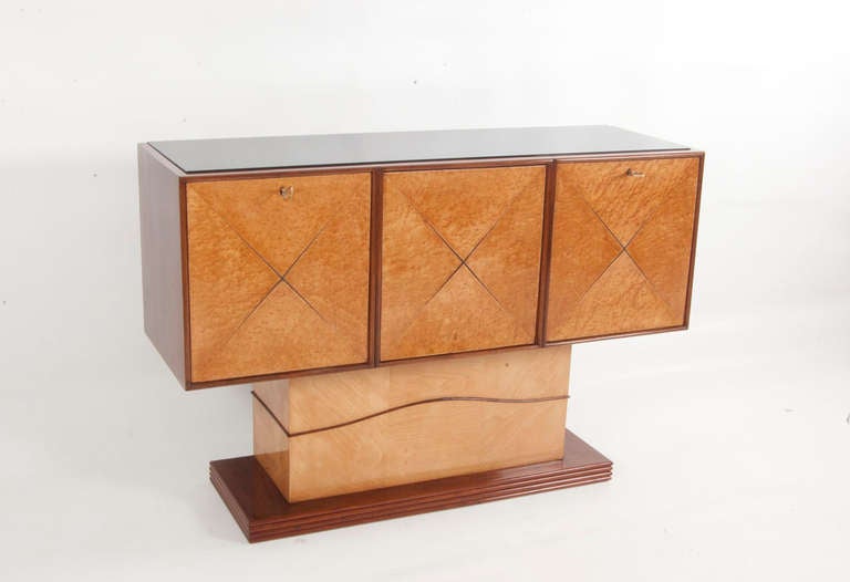 Extraordinary threepart Italian bar from the 1930s. The root wood is integrated in the mahagony corpus. The pedestal and interior are made of mable wood.

This Design was depicted in: I. de Guttry/ M.P. Maino, Il mobile déco italiano 1920-40,