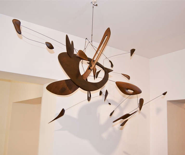 This stunning object is a mobile by the German artist Derick Pobell from 2012. The hand carved mobile is made out of balsa wood and suggests a special airiness. The fine balance is characteristic for Pobells voluminous mobiles. The diversity of the