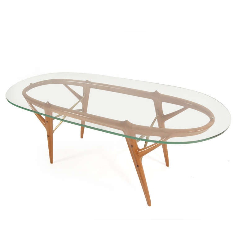 This particular table consists of an oval shaped glass plate and the noteworthy sapele wood construction. The wood has a very warm tonality and the shape has a truely 1950s flair. This design is playful and elegant at the same time, it refelcts Ico